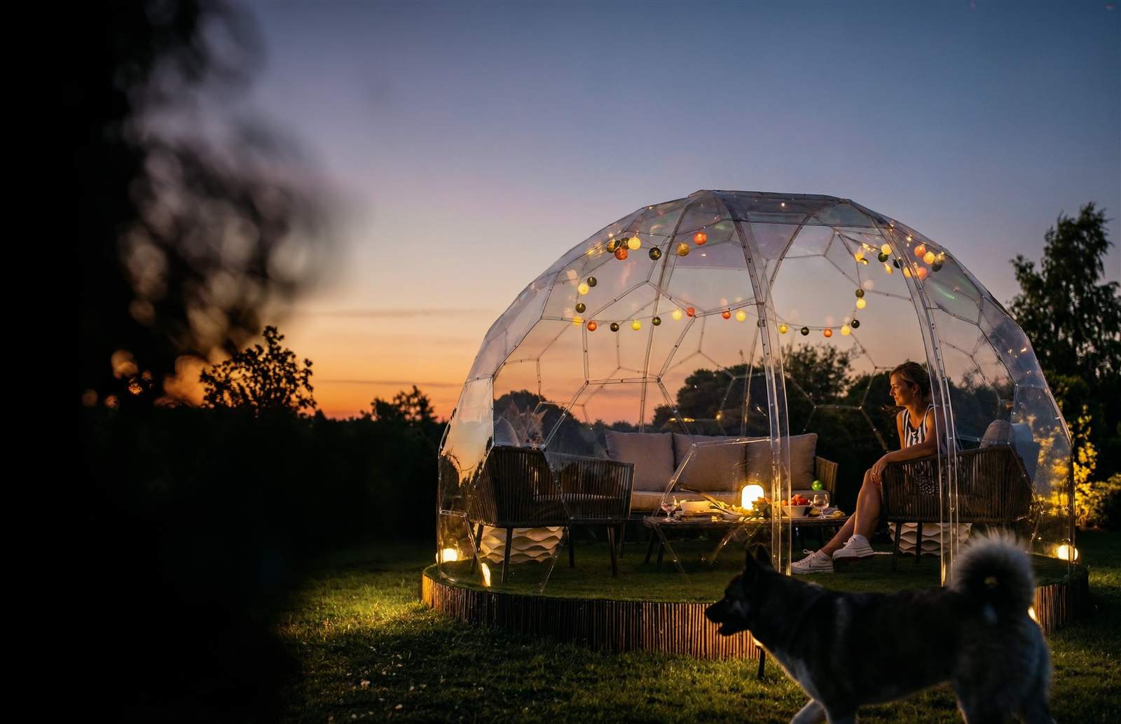 GeoDomeX garden dome at dusk with fairy lights