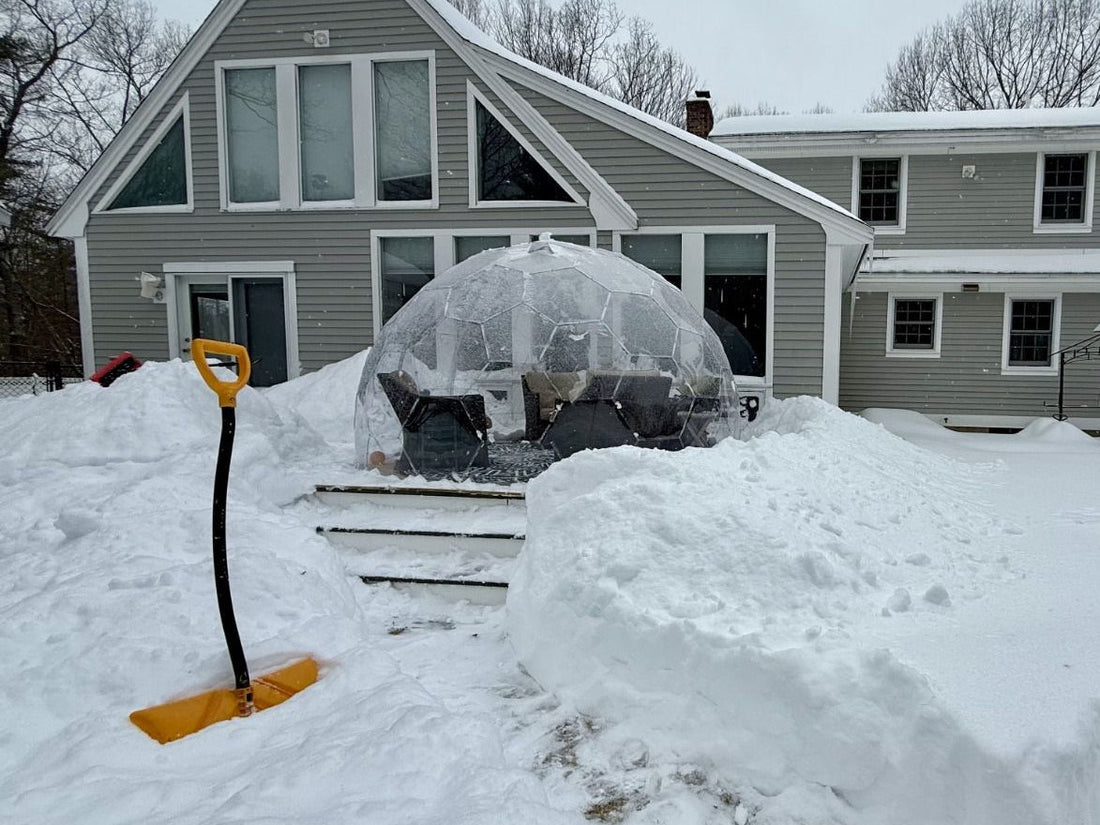 A GeoDomeX dome standing in deep snow in a back garden